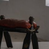 Dark red upholstered camel saddle stool, 20th century, North Africa.