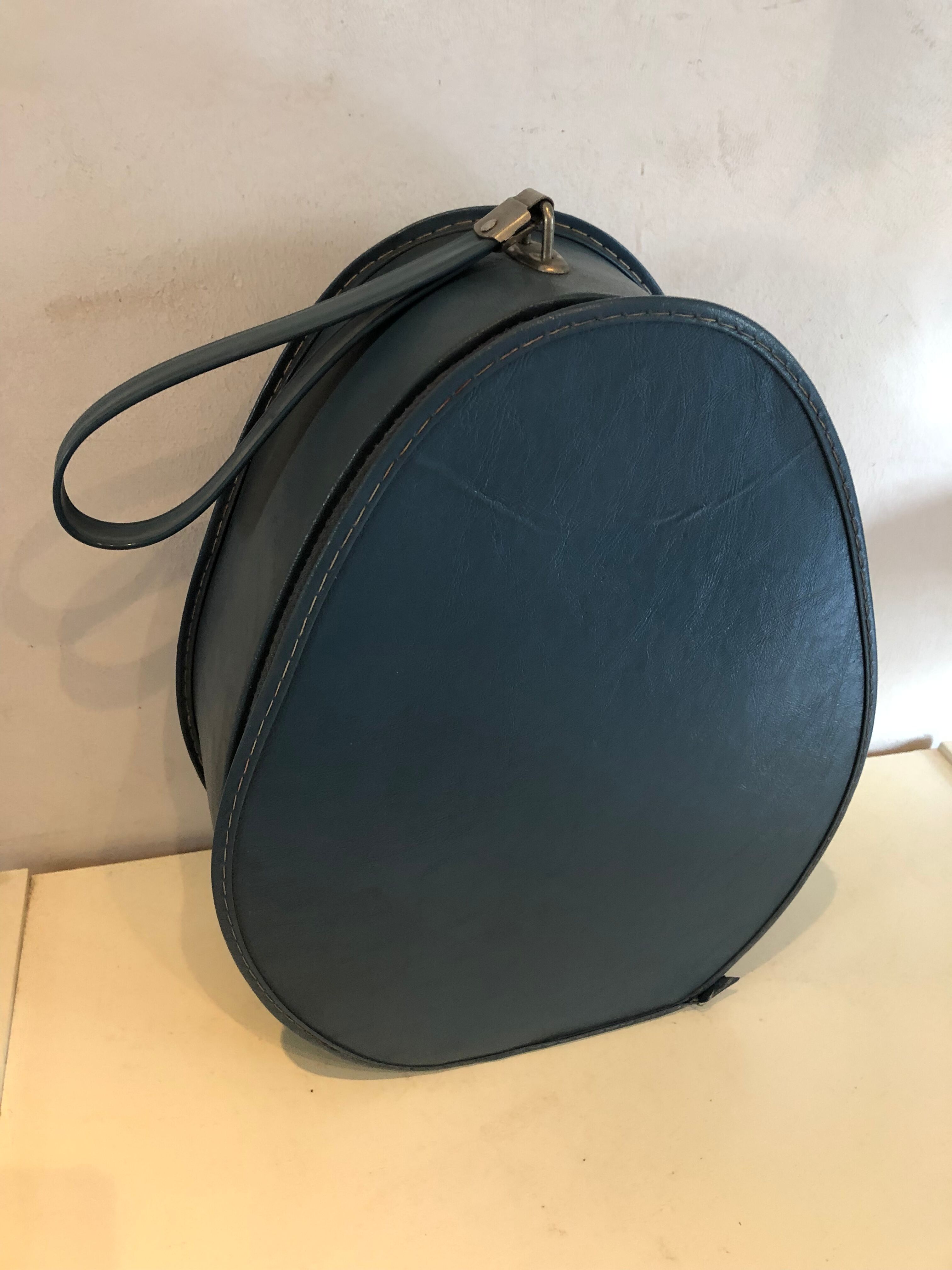 Suitcase has an air hostess hat