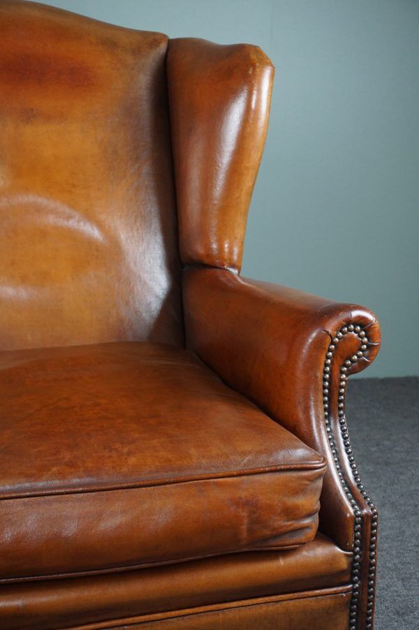 Eared armchair in patinated sheepskin