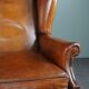 Eared armchair in patinated sheepskin