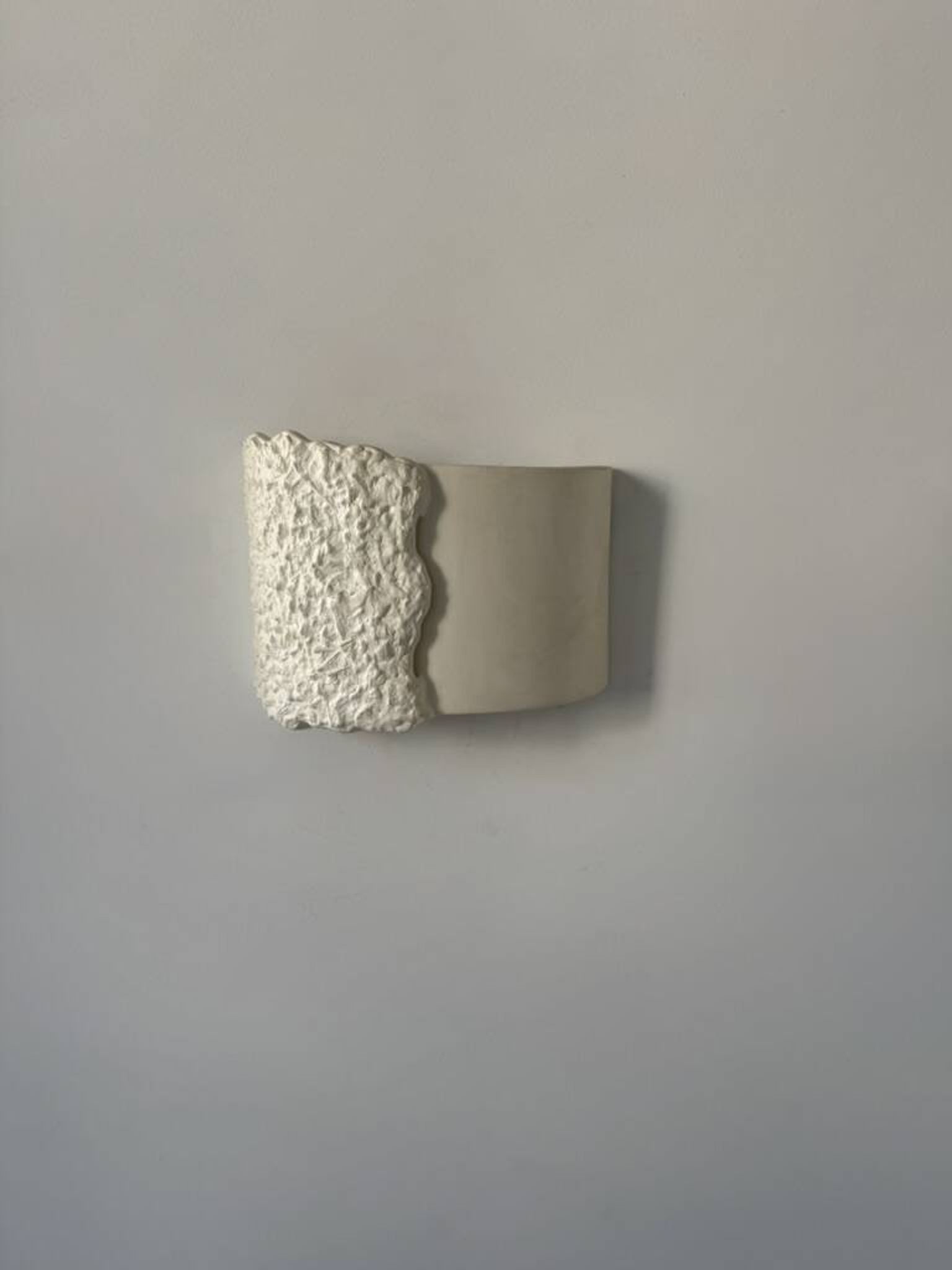 Pair of vintage wall lights in smooth plaster and stone imitation, France, 1970.