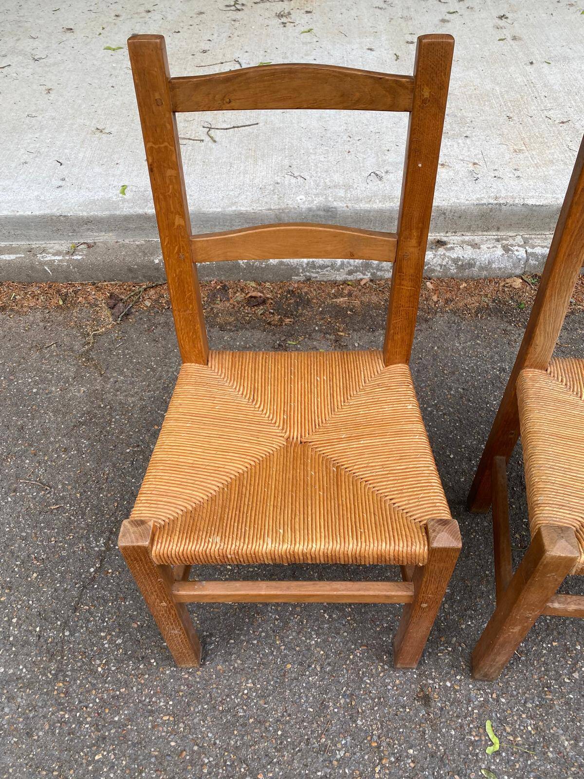 2 solid wood and straw chairs