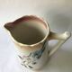 Antique barbotine pitcher with floral decoration numbered 548