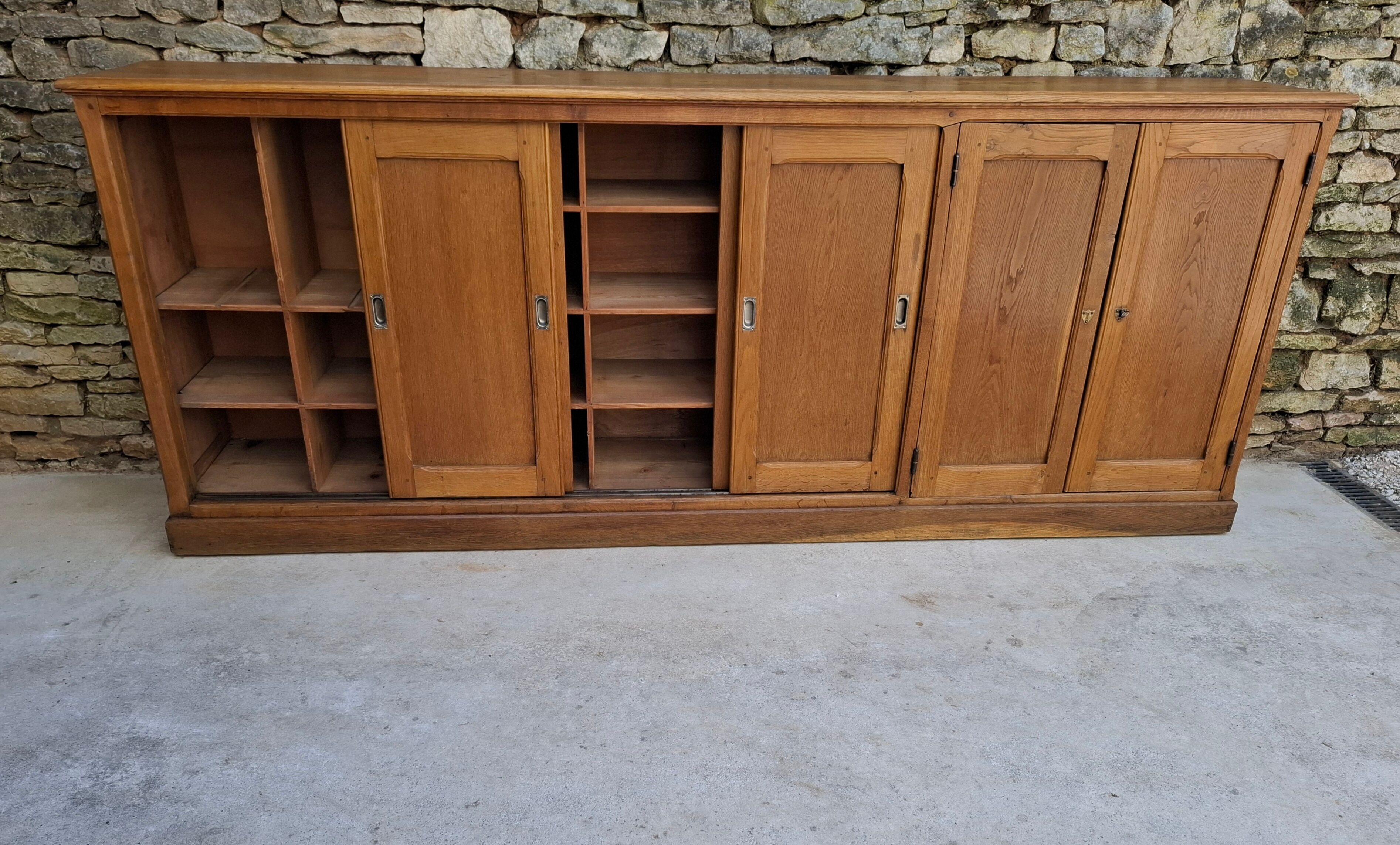 Oak workshop furniture with sliding doors.
