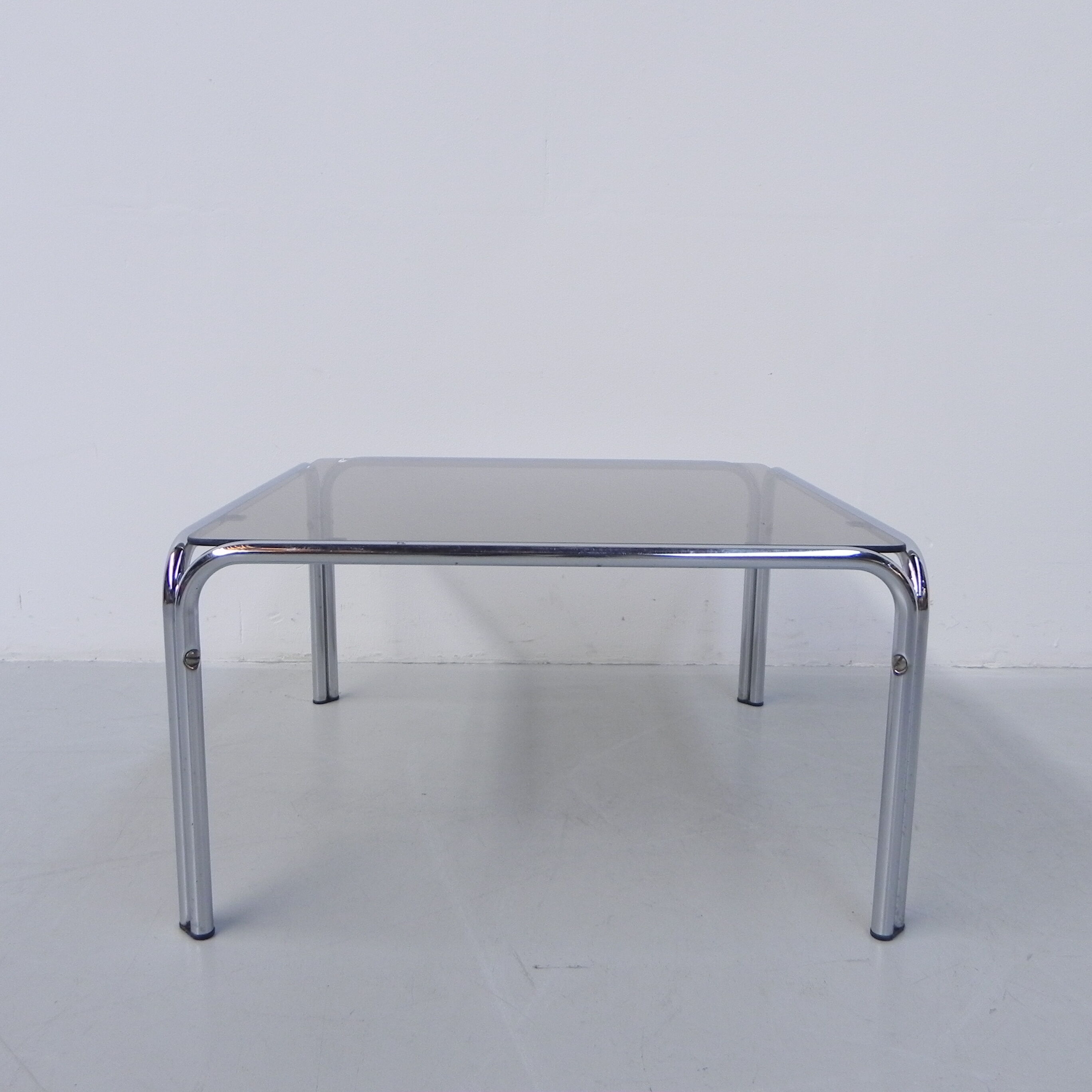 Coffee table with smoked glass top in chromed frame