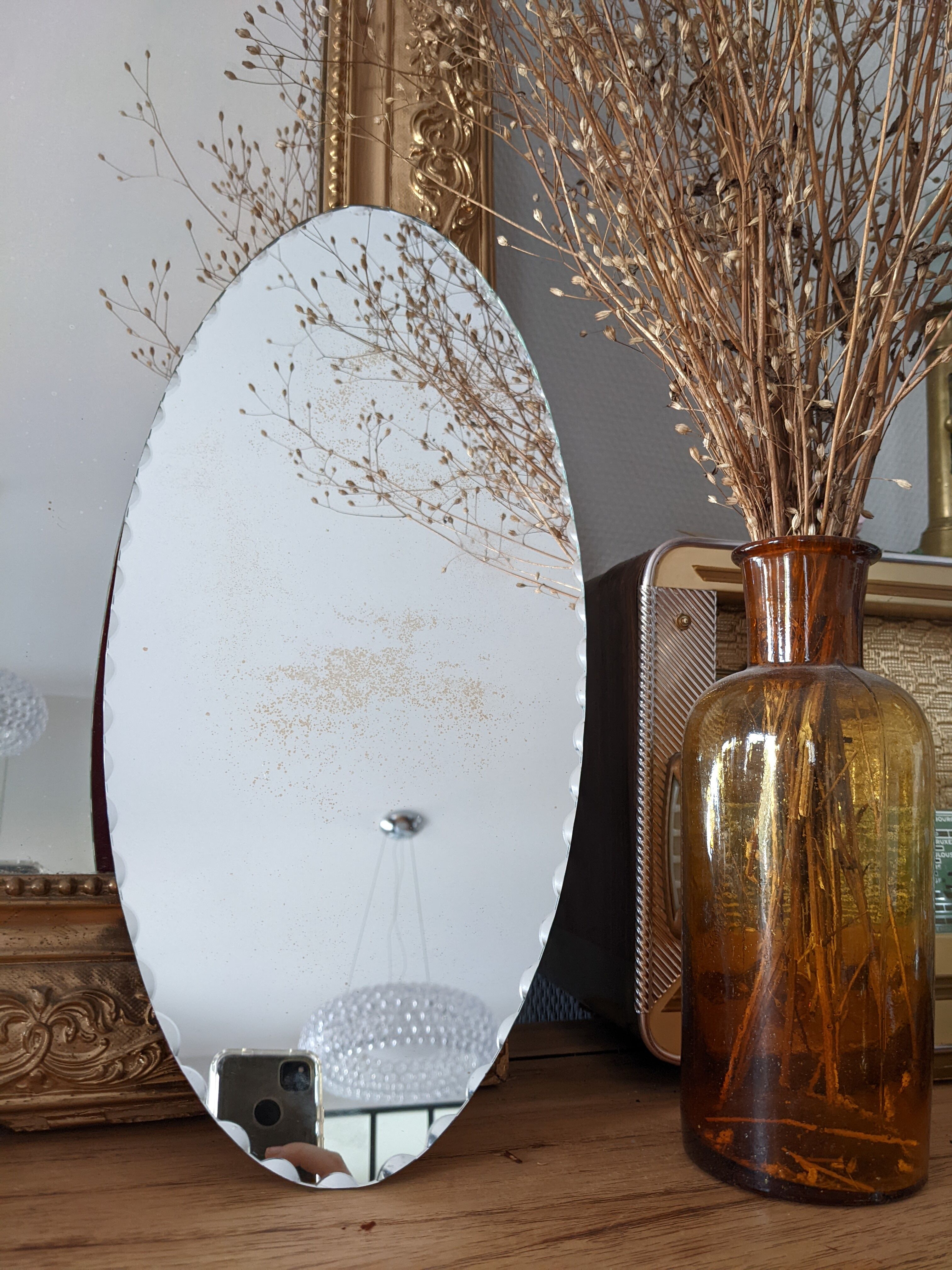 Vintage chiseled bevelled mirror under oval velvet