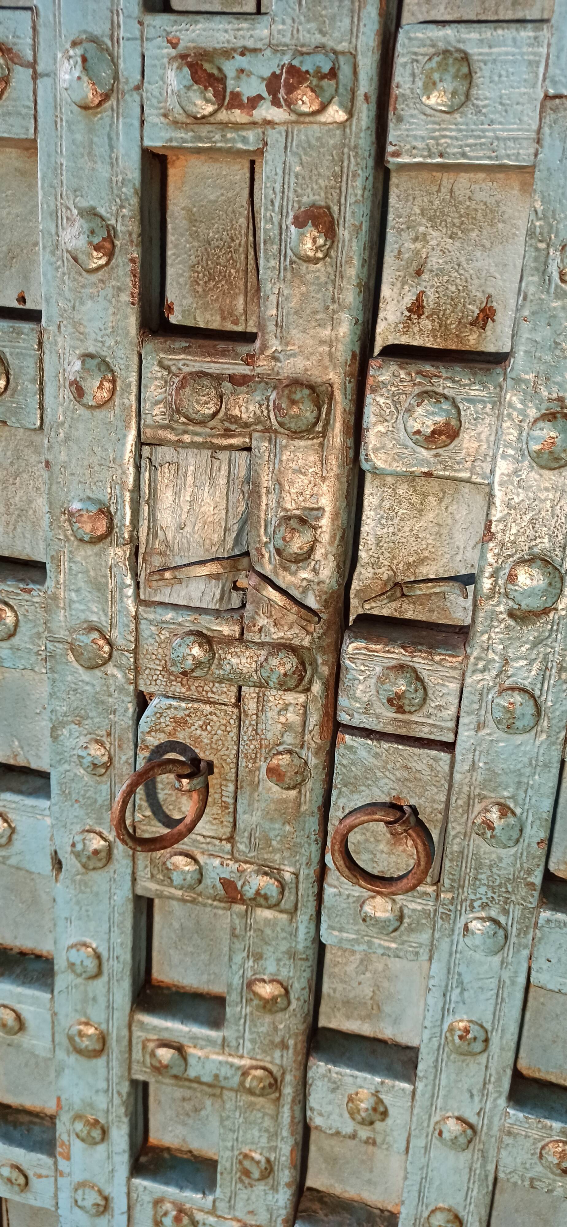 Old blue wooden door with braces