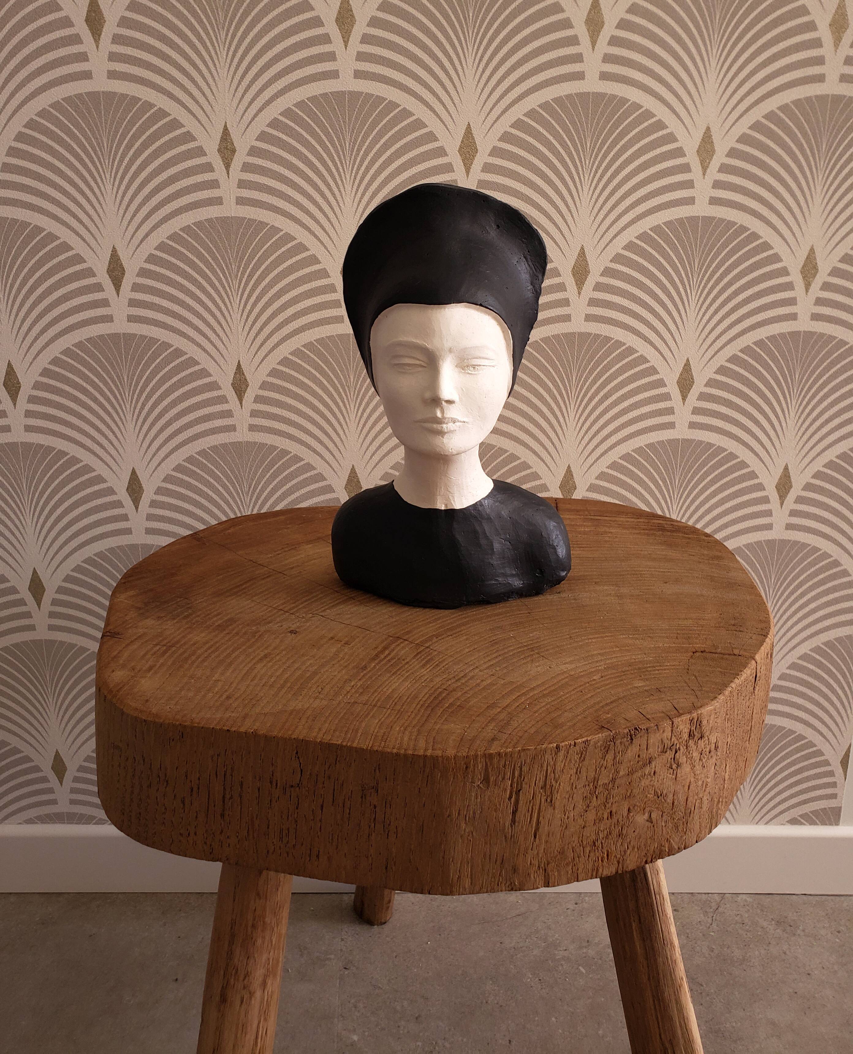 Bust of a woman in anthracite and white plaster