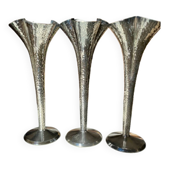 Triptych of hammered silver metal vases