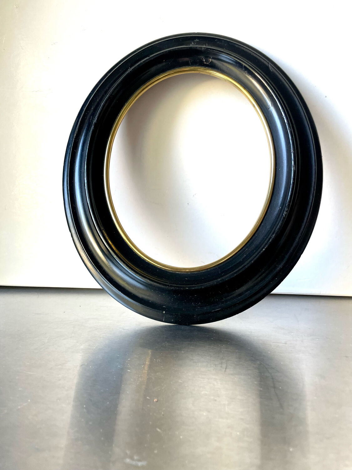 Black wooden oval frame