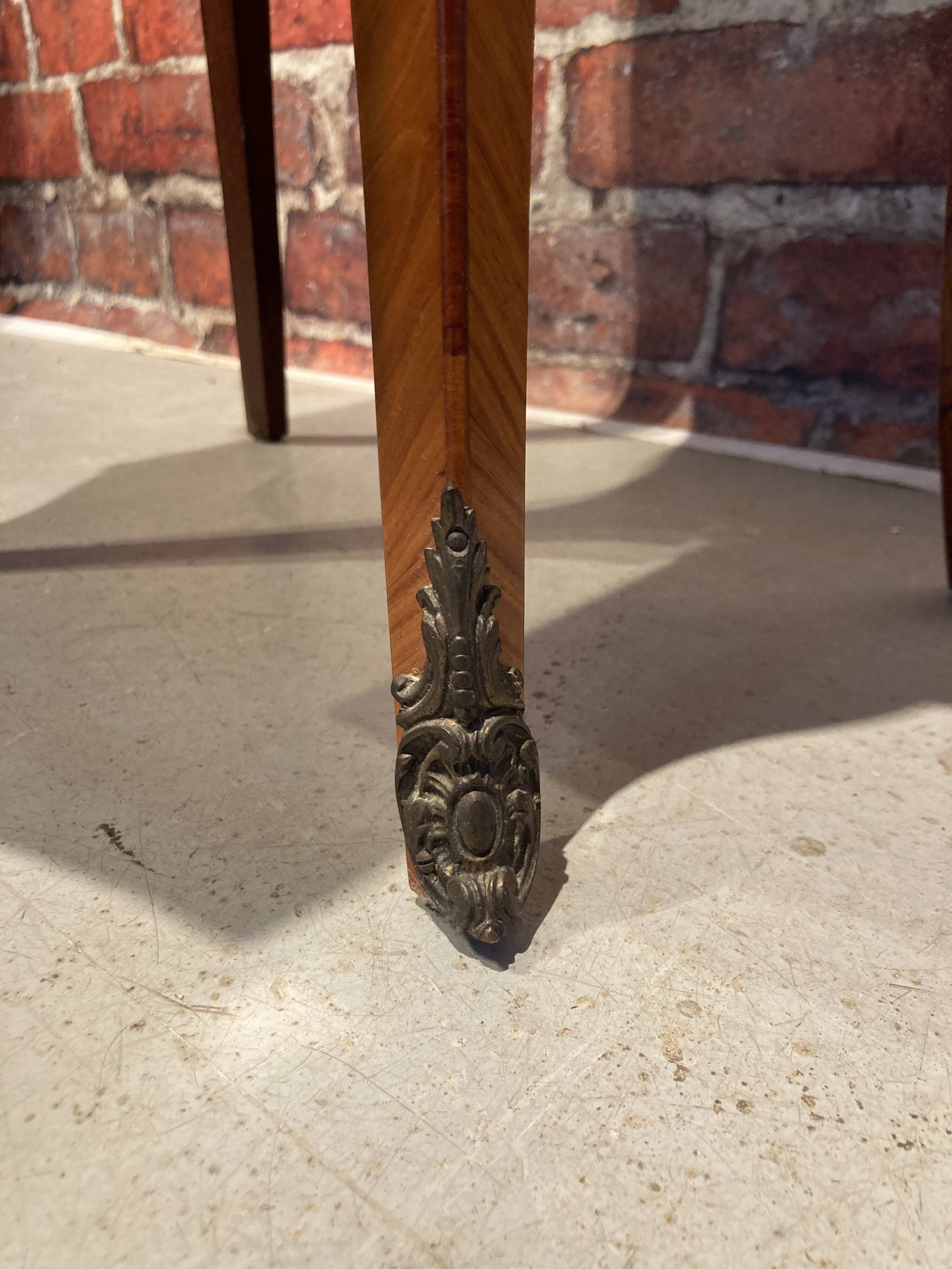 Wooden bedside table topped with a pink marble top
