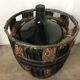 Dame jeanne de 100 litres avec son panier en métal