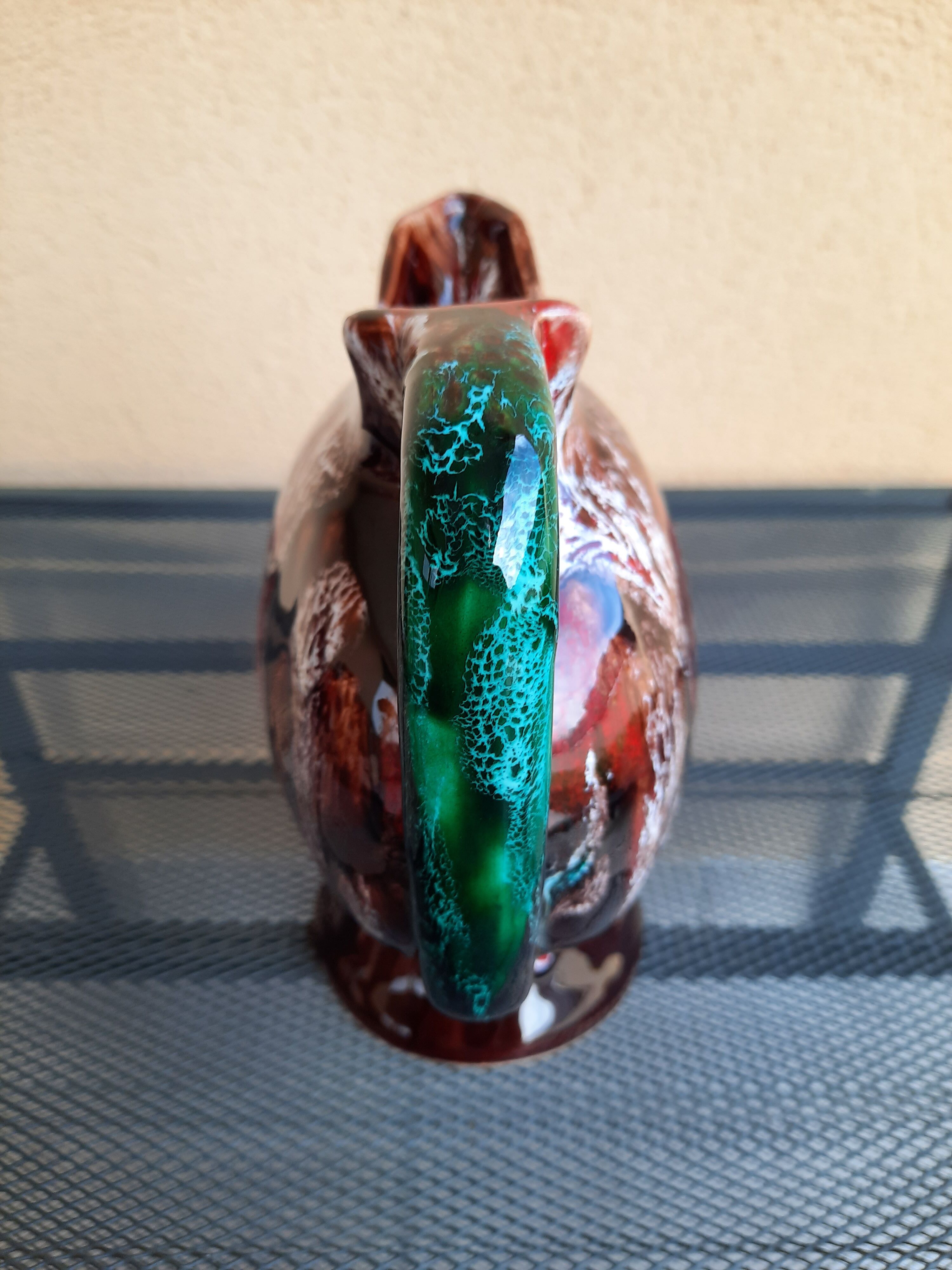 Earthenware pitcher signed vallauris, brown, orange, green, flammé décor, tbe.