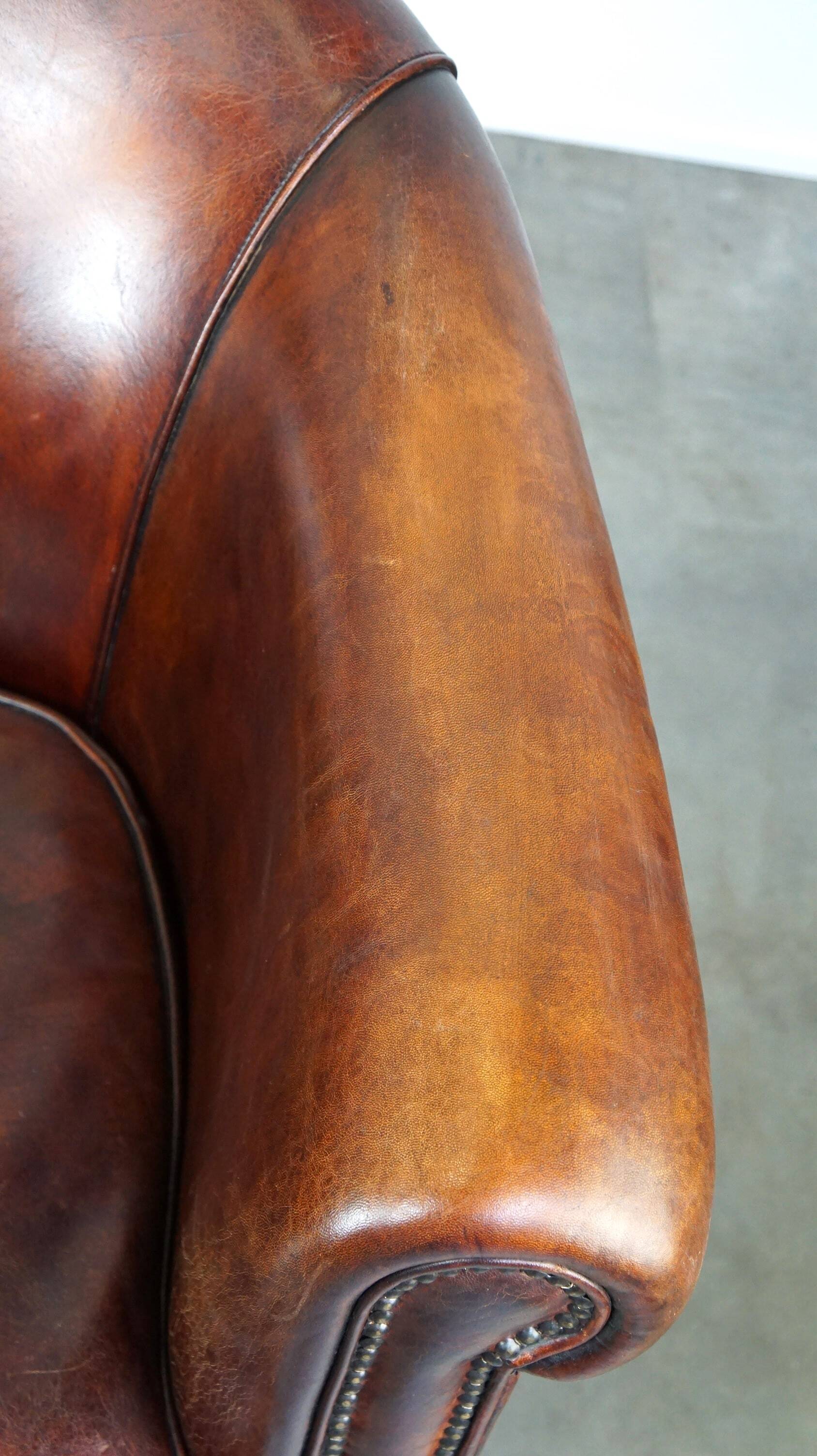 Very luxurious dark brown sheepskin club chair with a more than beautiful patina