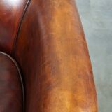 Very luxurious dark brown sheepskin club chair with a more than beautiful patina