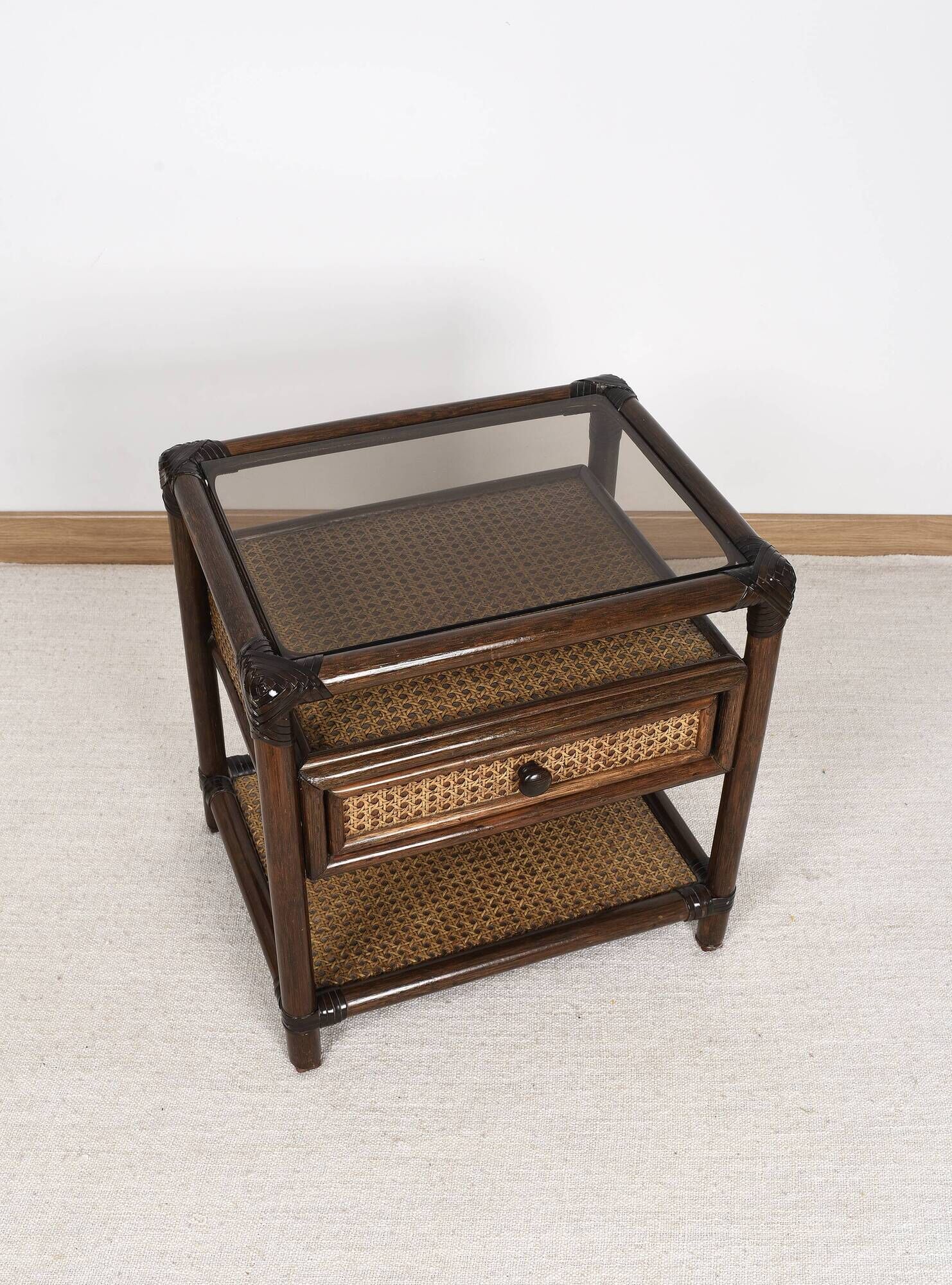 Rattan and cane bedside table, smoked glass top