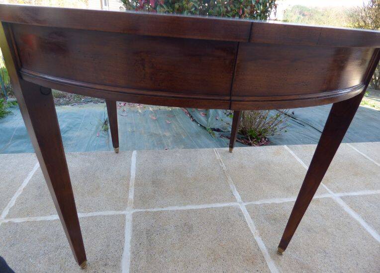Round mahogany table with mahogany veneer and brass sabot foot.