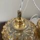 Set of two suspensions in gilded chiseled glass