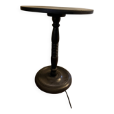 Black lacquered gueridon with spool legs.