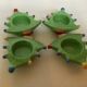 Four Christmas tree-shaped candle holders