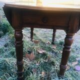 Extendable round table in walnut wood 1930