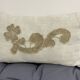 Cushion in vintage fabric with ornamentation.