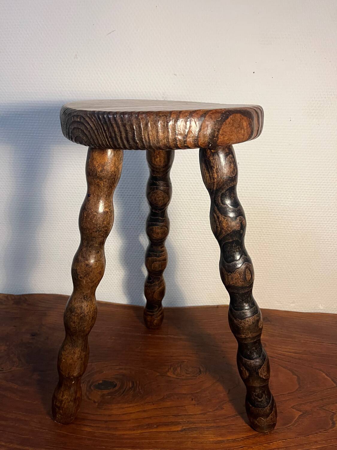 Round wooden tripod stool