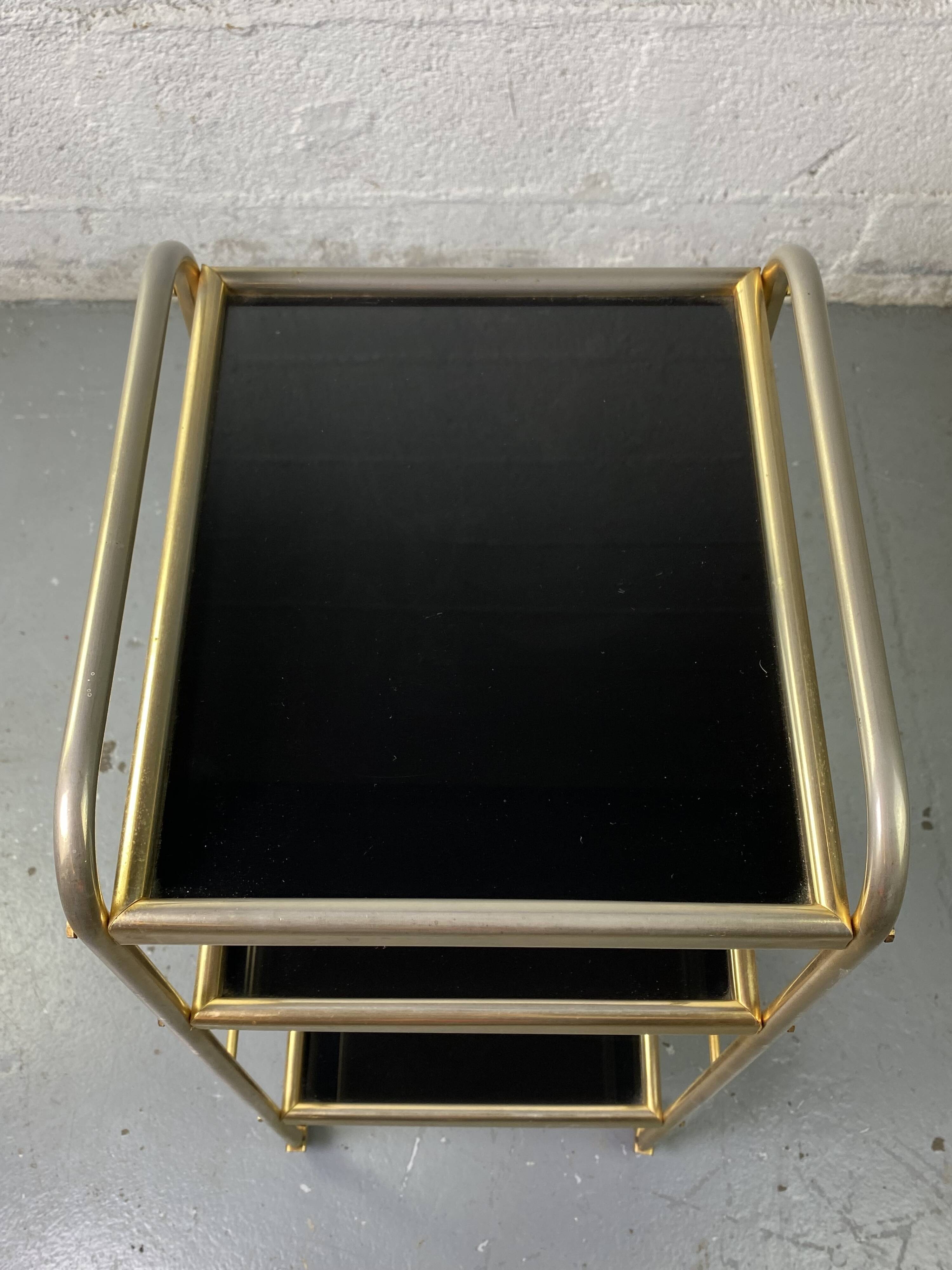 Small rolling trolley in brass and black plastic