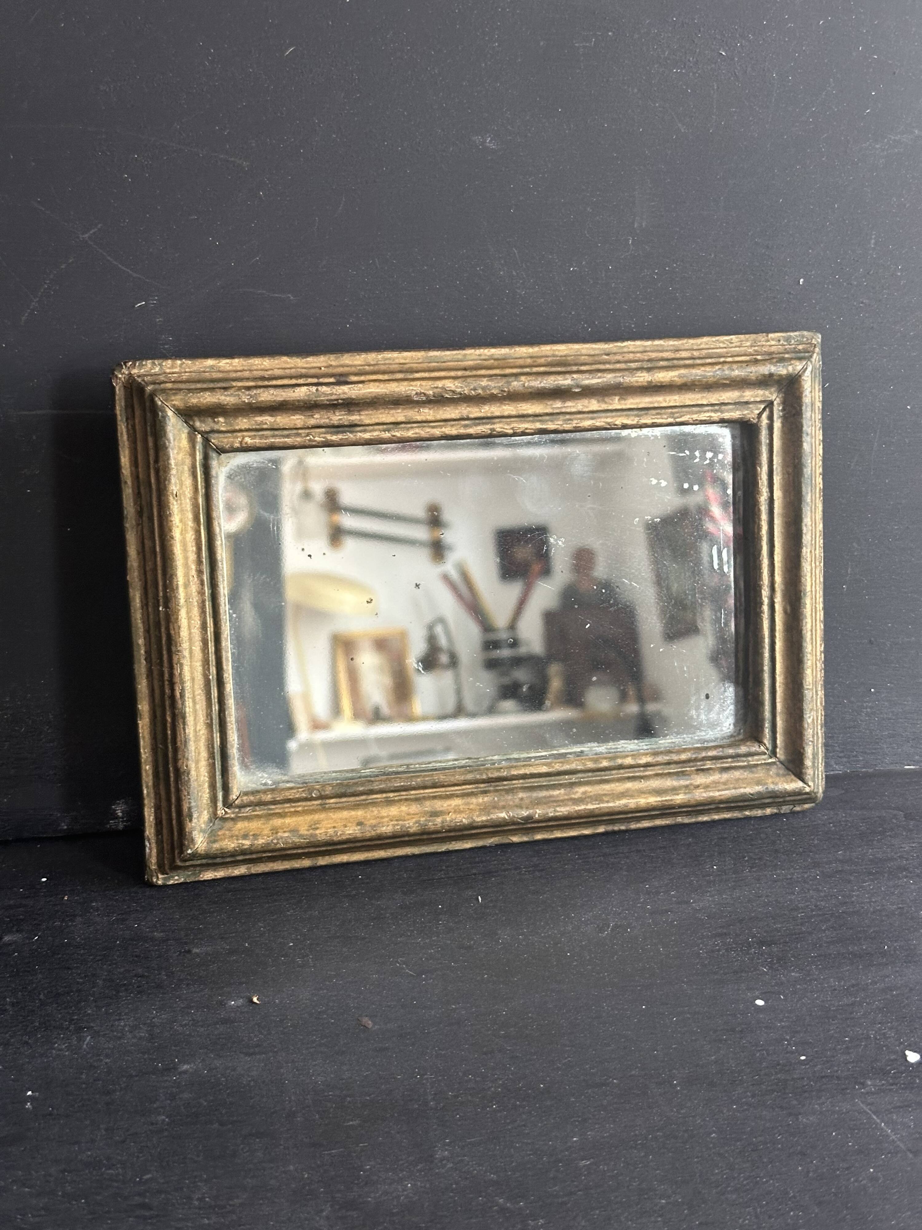 Miniature mirror from the 18th century in gilded wood, mercury glass.