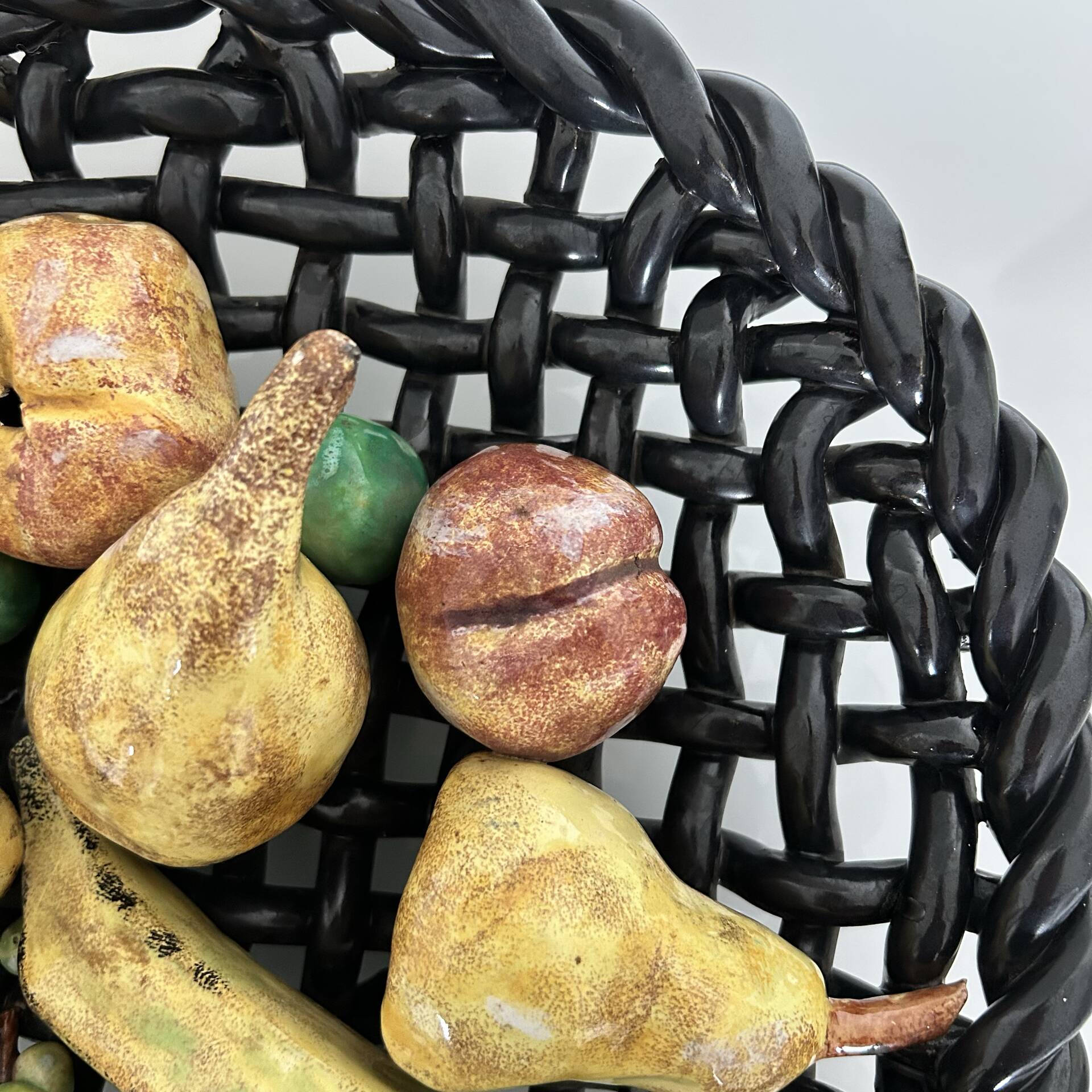 Large woven bowl and trompe l'œil fruits