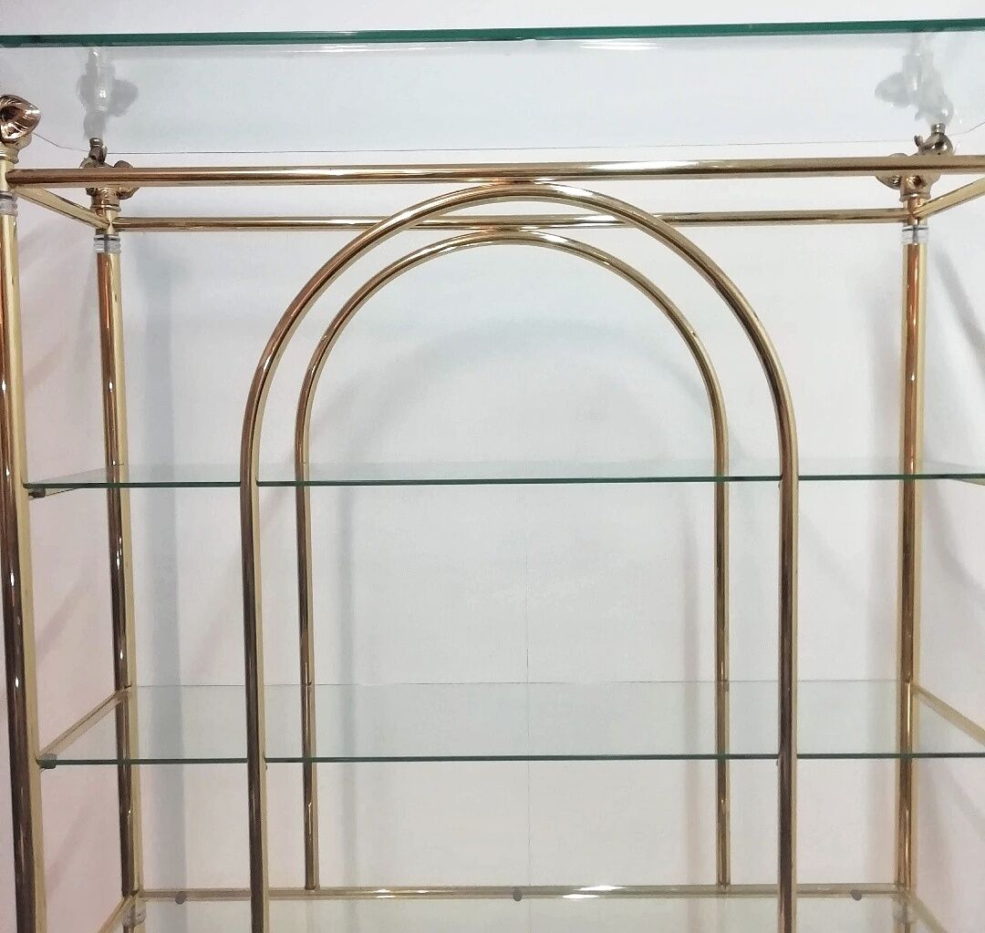 Hollywood Regency brass and glass shelf with elephant heads from the 1970s