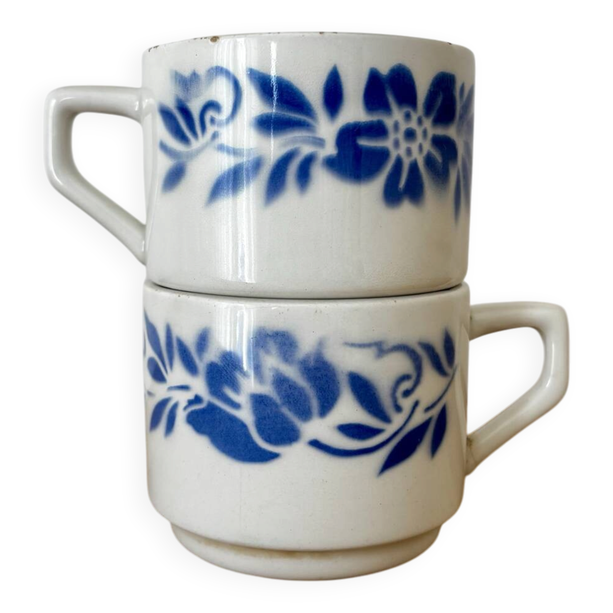 Set of 2 antique earthenware cups with blue floral pattern.