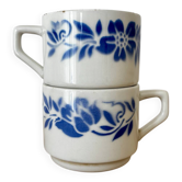 Set of 2 antique earthenware cups with blue floral pattern.