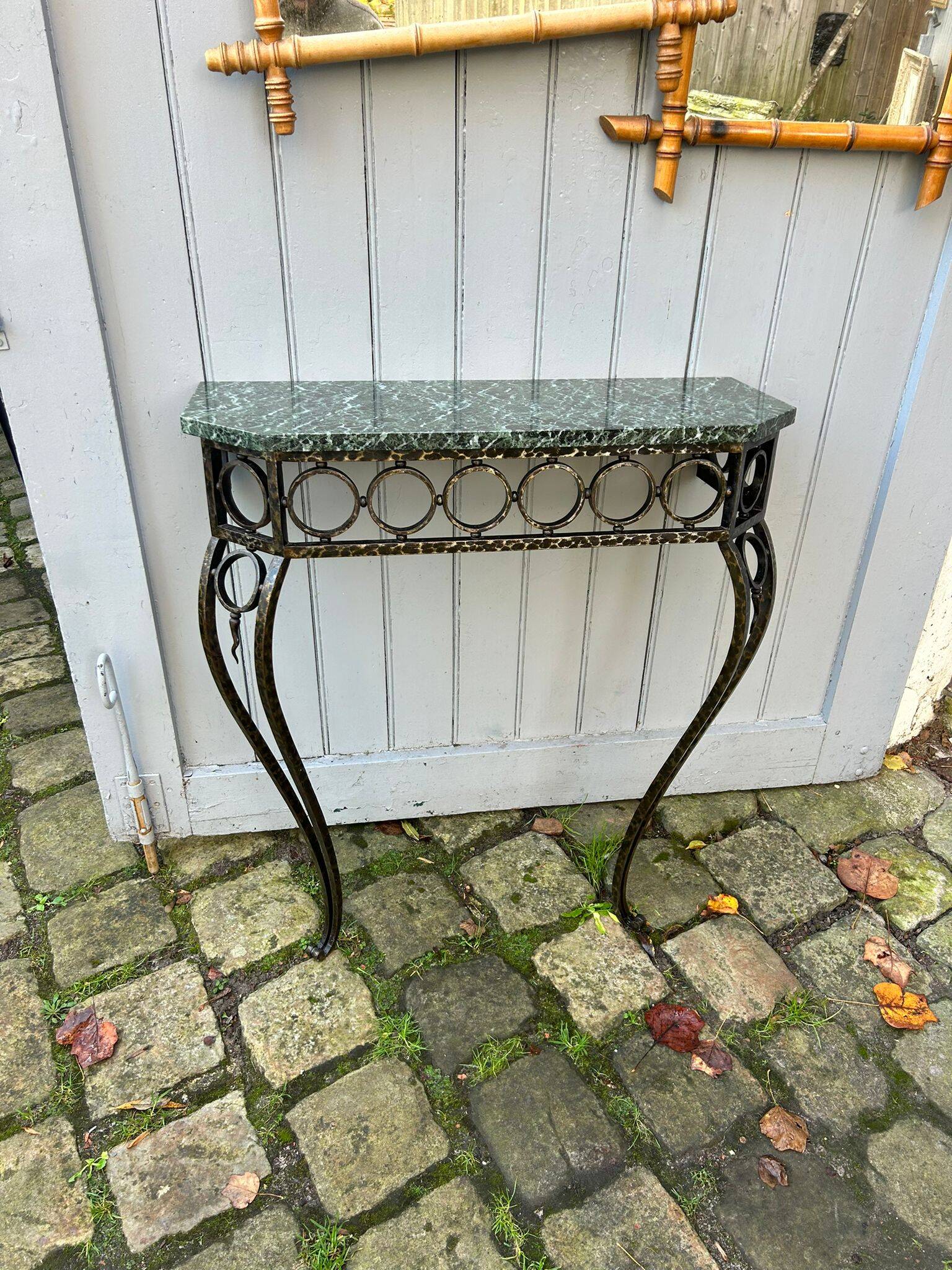Console in wrought and hammered iron and green marble