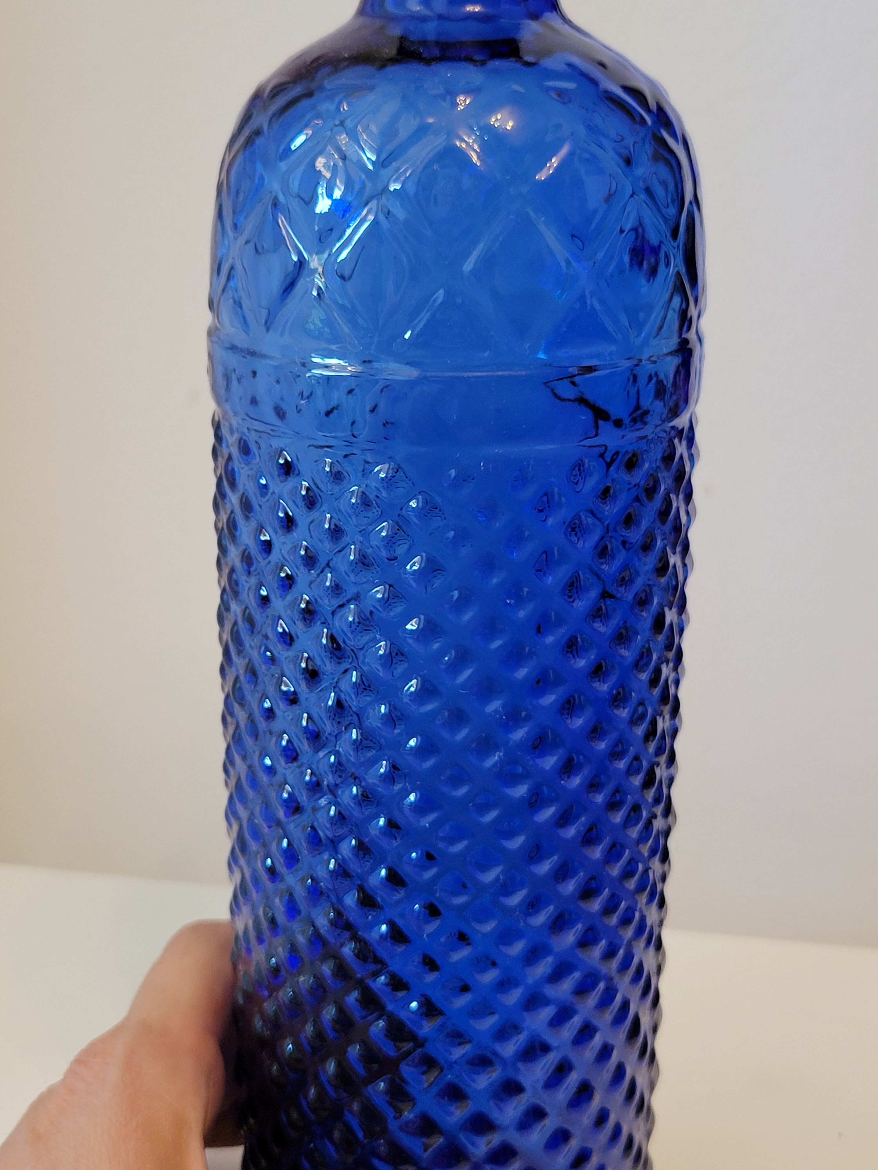 Vintage decanter bottle made of blue molded pressed glass