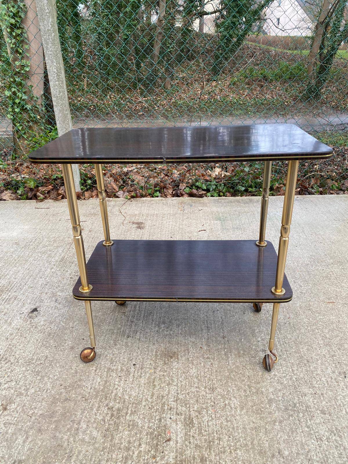 Brown rosewood rolling table with gold legs