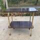 Brown rosewood rolling table with gold legs