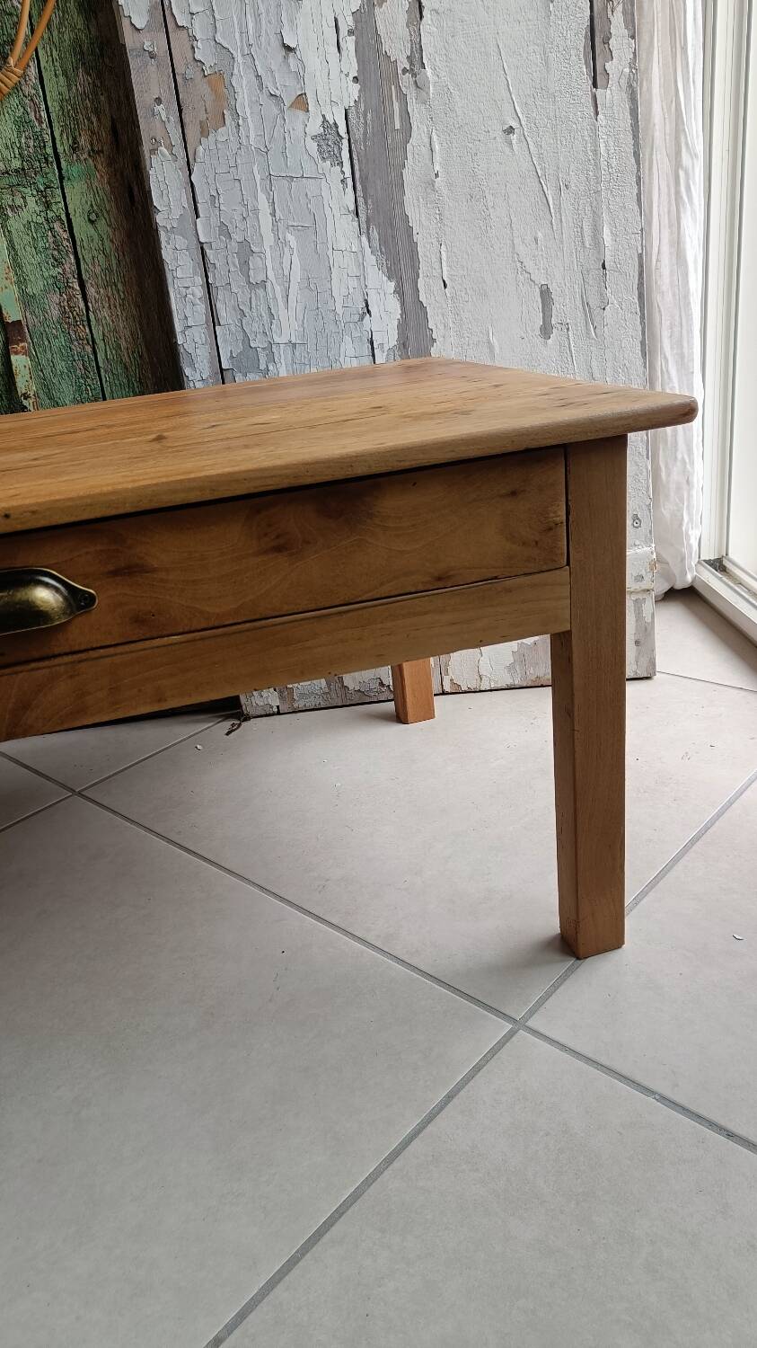 Coffee table with raw wood and a large drawer.