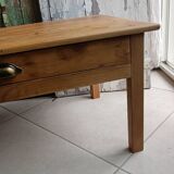 Coffee table with raw wood and a large drawer.