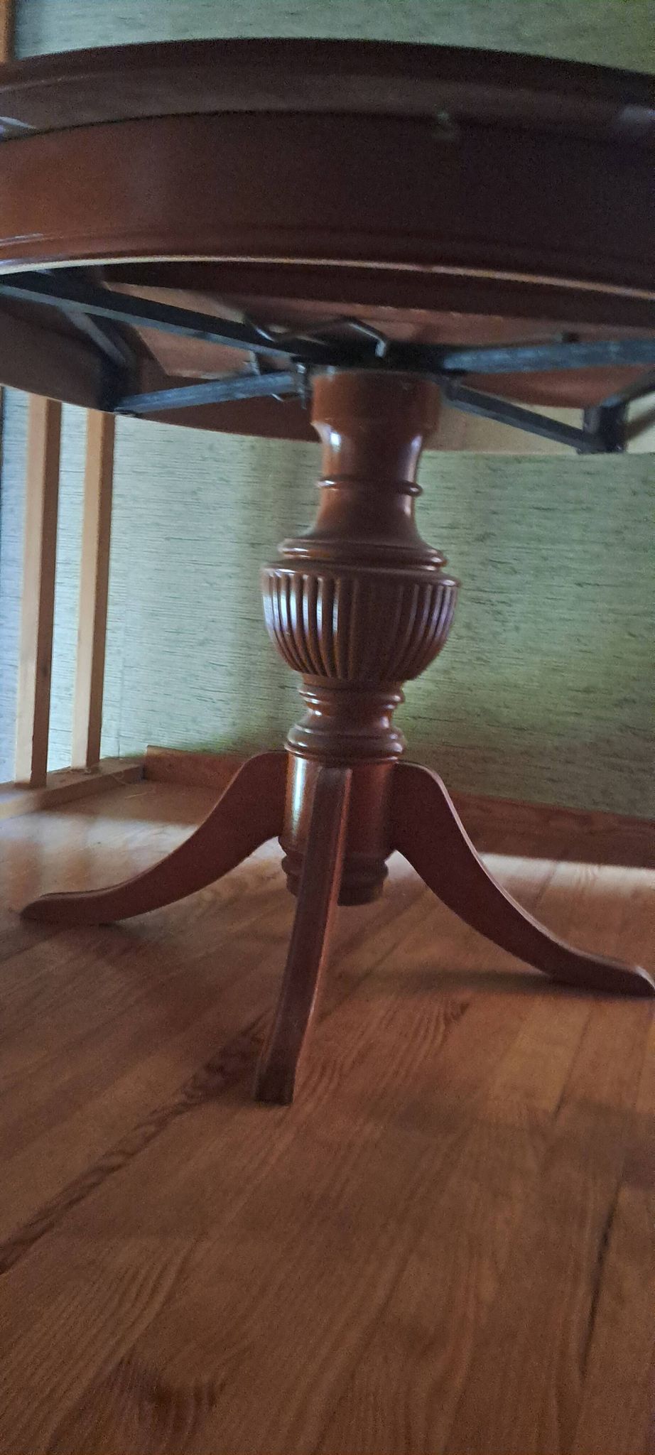Round solid walnut table with central leg from the 1950s with extensions.