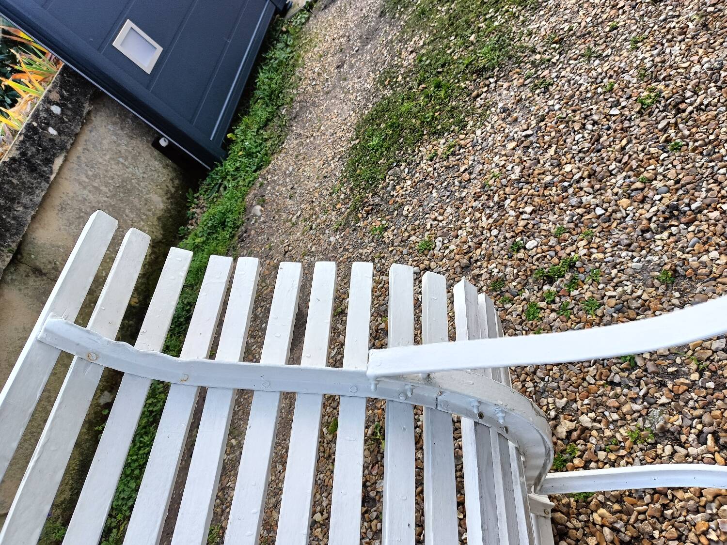 Old garden bench with metal legs and wooden slats