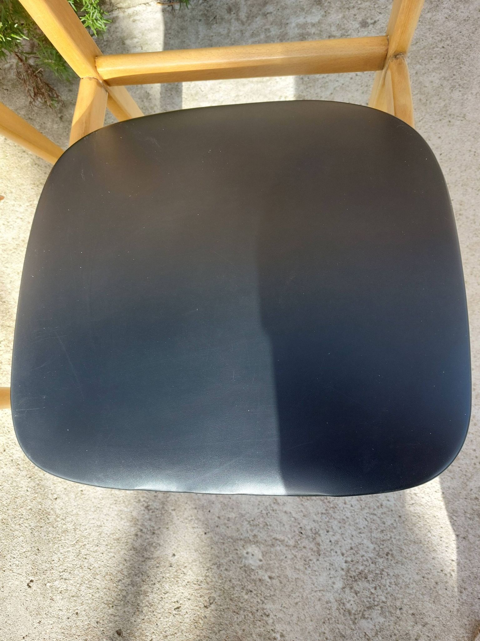 3 Scandinavian style chairs, light wood and black faux leather.