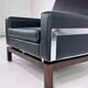 Pair of 50s-60s armchairs in imitation leather, wood and chrome