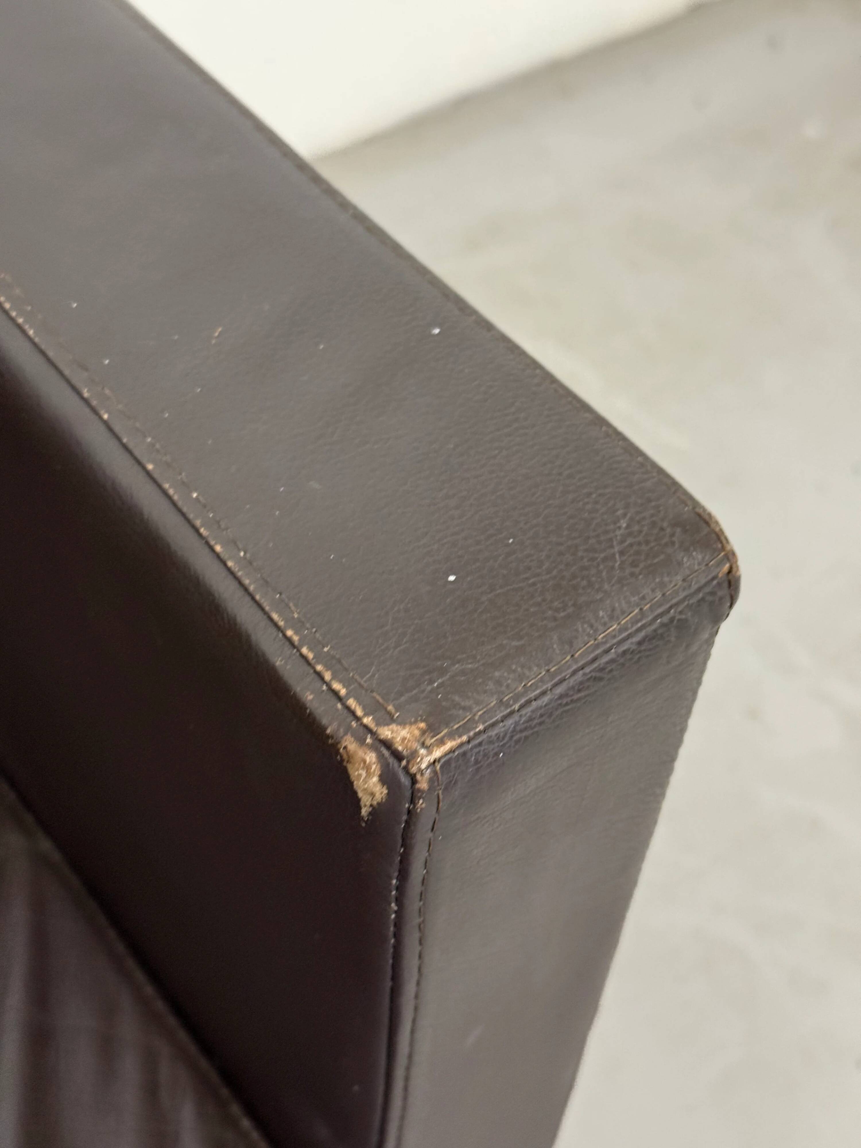Vintage brown leather club armchair with a swivel side table.