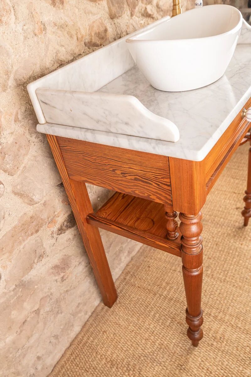Antique washbasin cabinet in solid pitch pine with a white marble top.