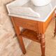 Antique washbasin cabinet in solid pitch pine with a white marble top.