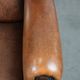 Sheepskin wingback armchair with decorative nails and black piping