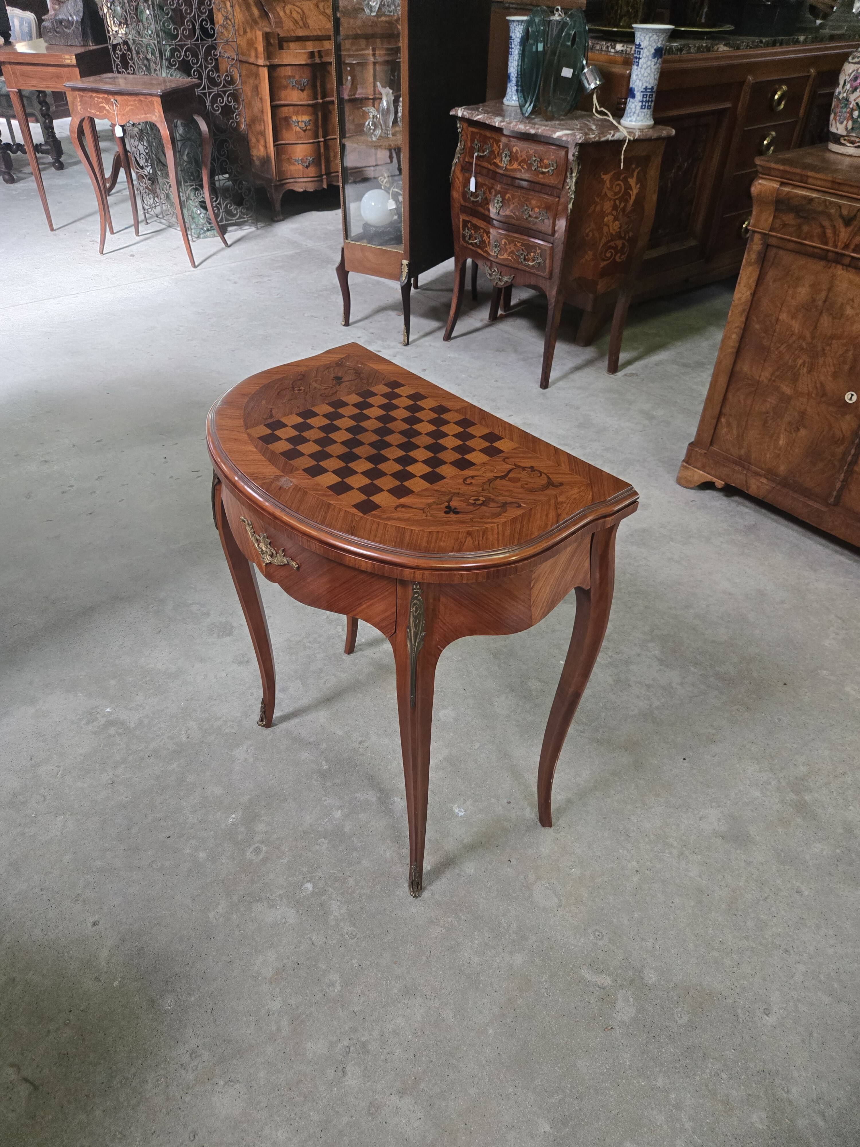 Half-moon gaming table in Louis XV style, made of precious wood marquetry.