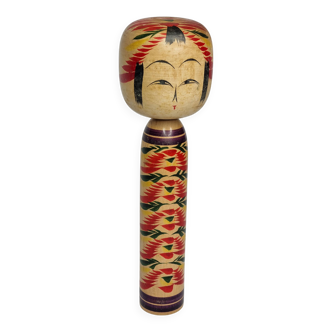 Japanese Kokeshi doll dated 1986, signed and numbered, hand-painted multi-colored floral decoration,
