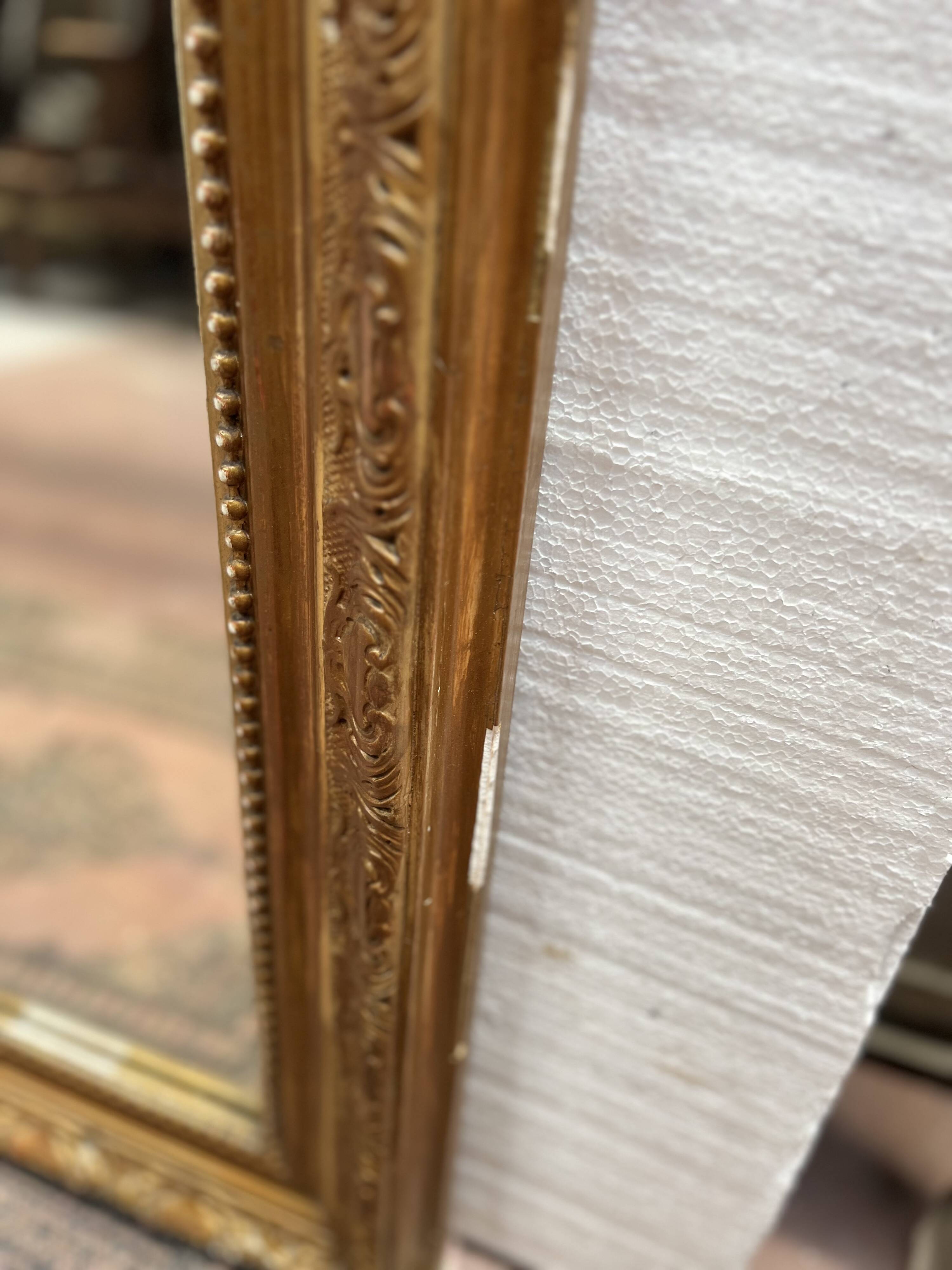 Louis XV style mirror in gilded wood and stucco, 20th century.